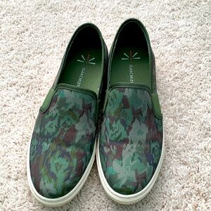 Green camo canvas slipons with white bottoms.
